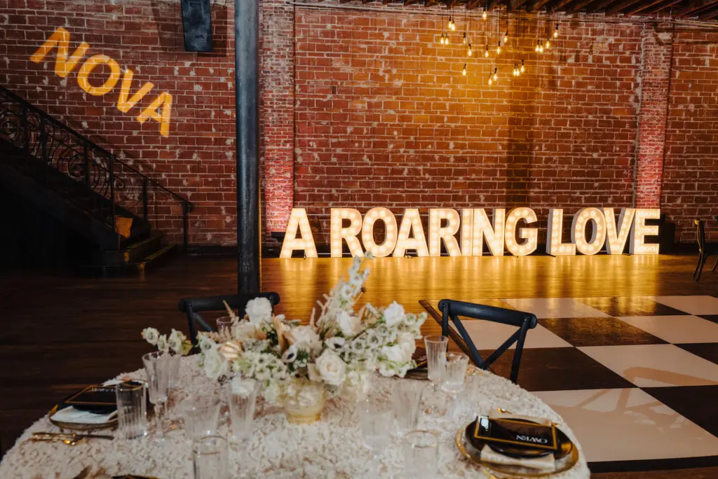 1920s Great Gatsby Big Light Up Letters with Checkered Dance Floor Wedding Receptions Ideas | St. Pete Venue NOVA 535 | Rentals Alpha Lit Letters | Kate Ryan Event Rentals