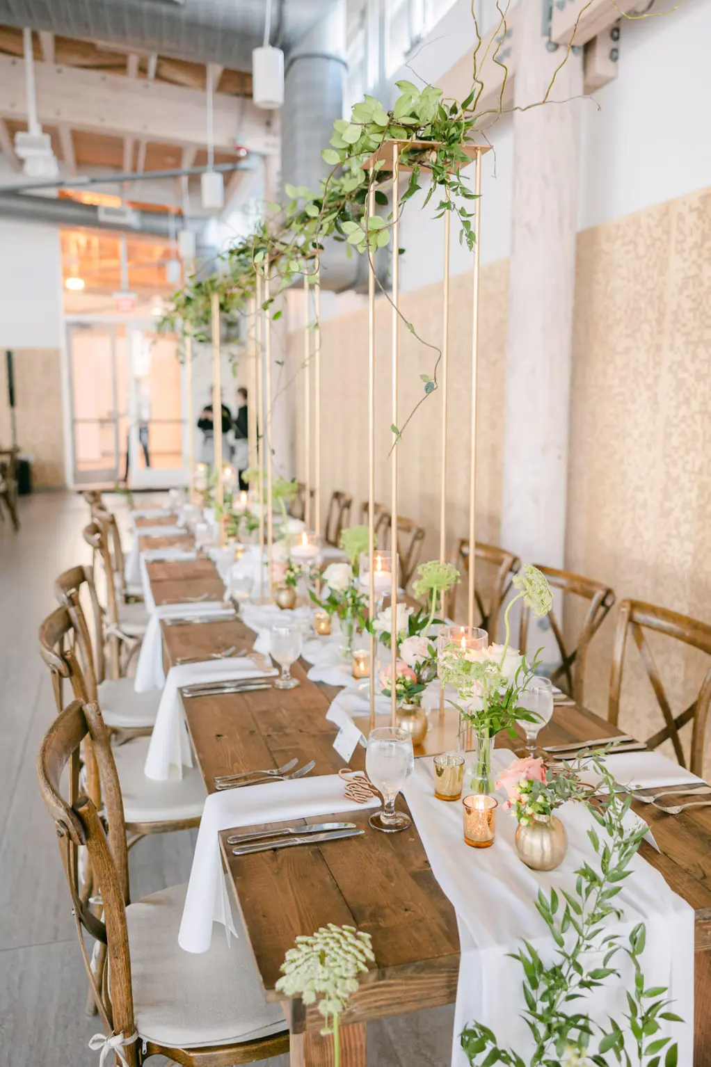Elegant Garden Wedding Reception Decor Inspiration | Rustic Long Wooden Feasting Table With French Country Cross Back Chairs | Floating Candles | Tall Flower Stand Centerpieces with Greenery Ideas | Downtown Riverwalk Event Venue Tampa River Center