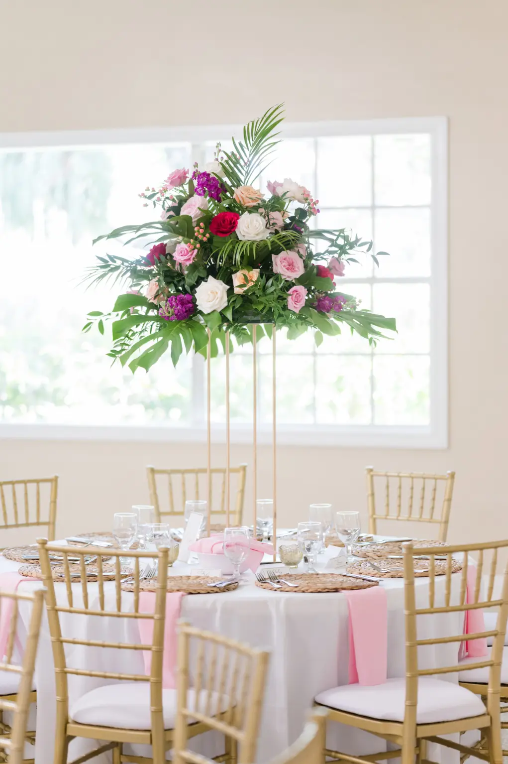 Elegant Tropical Tall Gold Stand with Greenery, Pink, Orange, White, and Purple Flowers | Vibrant Pink Garden Inspired Wedding Reception Centerpiece Ideas