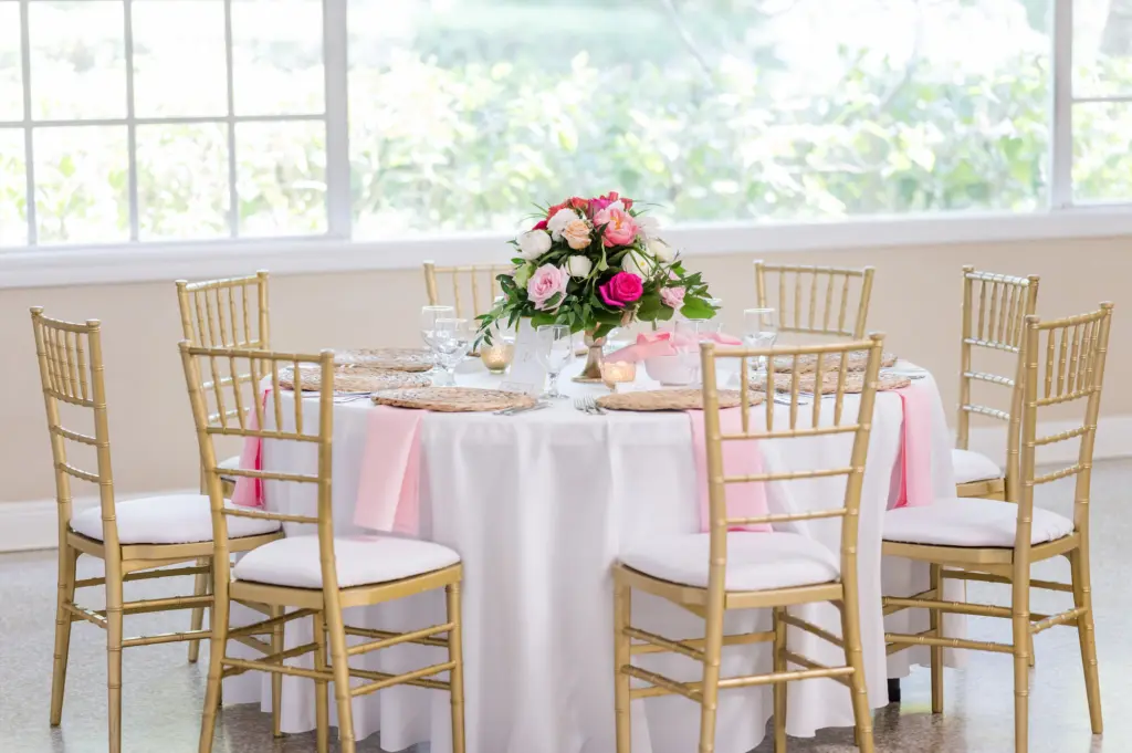 Elegant Garden Pink and Gold Wedding Reception Decor Ideas | Pink Roses and Greenery Centerpiece Inspiration with Hyacinth Place Mats and Pink Linen, Gold Chiavari Chairs