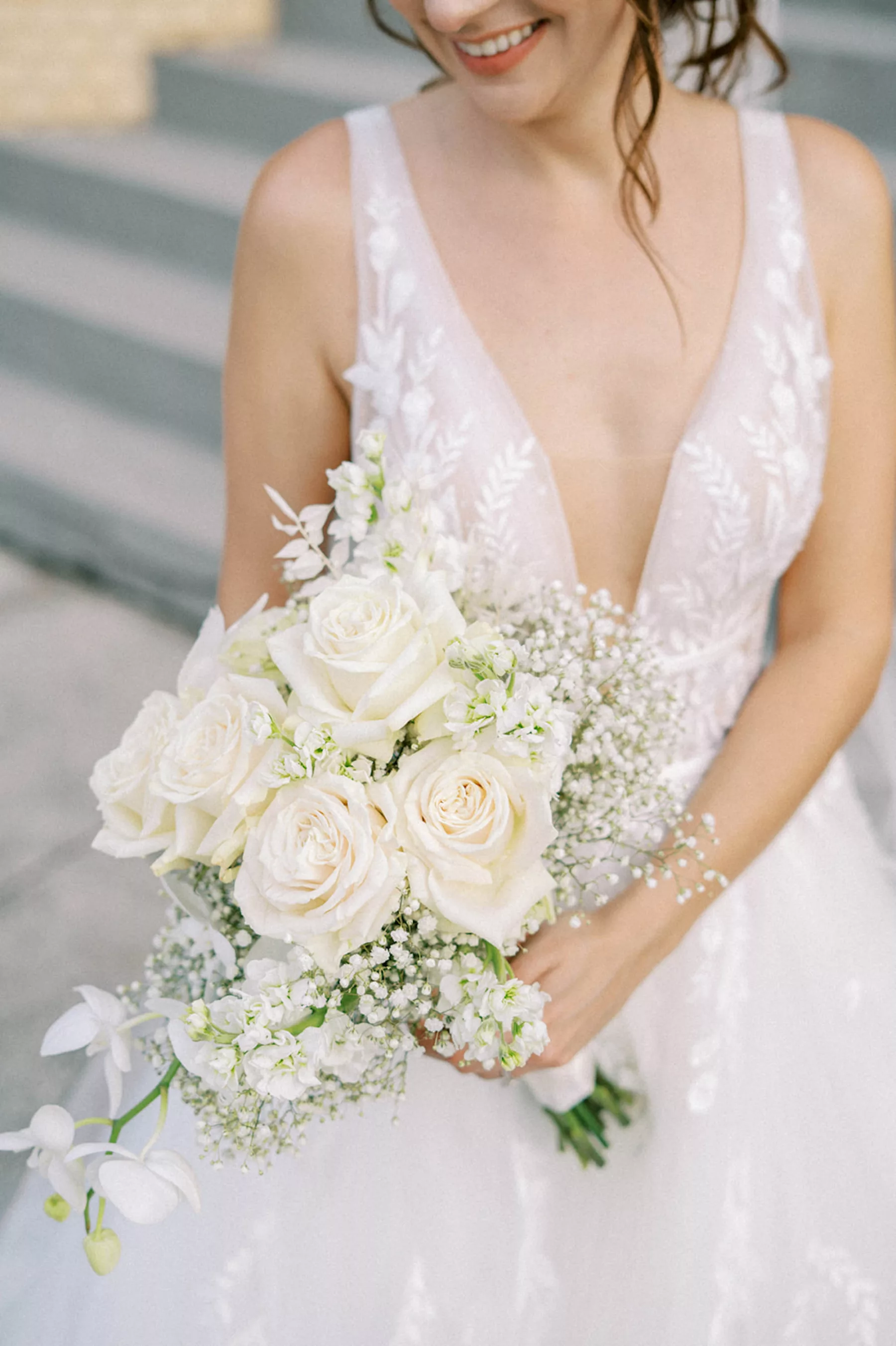 Elegant White Tulle Deep V Neckline A Line Wedding Dress Ideas | Monochromatic Bridal Bouquet with White Roses, Baby's Breath, Orchids, and Stock Flowers Inspiration