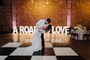 Black and White Checkered Wedding Reception Dance Floor Inspiration | Feathered One-Shoulder Wedding Dress Ideas | Alpha-Lit Tampa St Petersburg | Event Venue Nova 535 | Boutique Truly Forever Bridal | Videographer Sabrina Autumn Photography | Planner Kelci Leigh Events