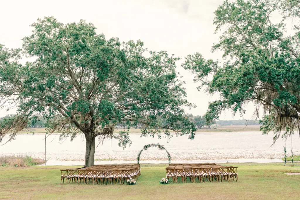 Elegant Lakeside Wedding Ceremony Decor Ideas | Round Arch with Greenery and Pink Roses Inspiration | Tampa Bay Planner The Olive Tree Weddings