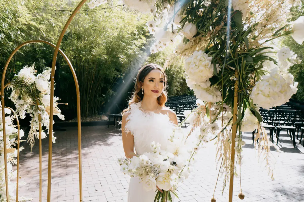 Gold Metal Hoop Arch for Modern Great Gatsby Inspired Wedding Ceremony with White Hydrangea and Roses | Feathered Wedding Dress | St Pete Boutique Truly Forever Bridal | Tampa Bay Photographer McNeile Photography | Florist Marigold Flower Co