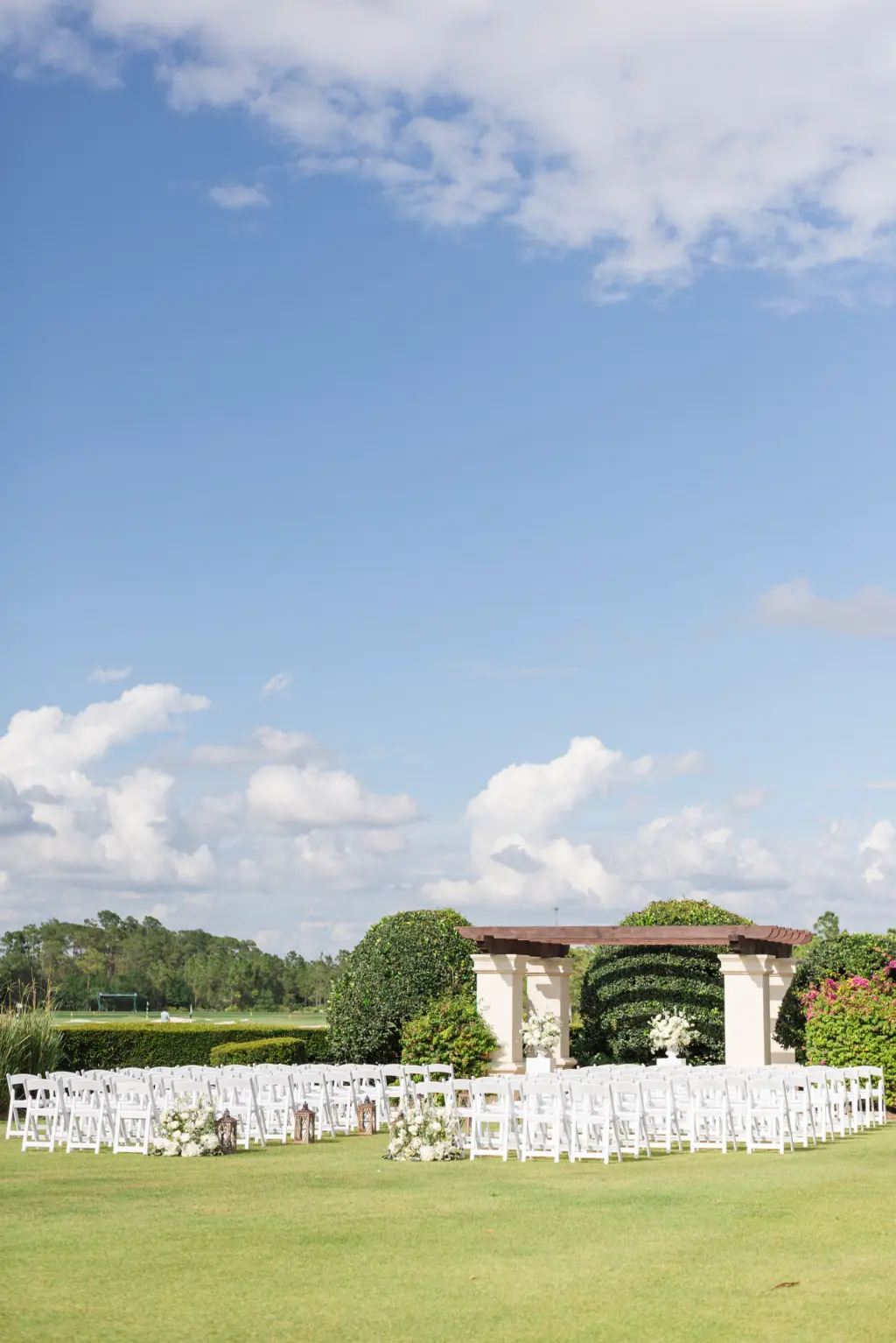 Elegant Outdoor Wedding Ceremony on Event Lawn | White Garden Chairs and Wooden Pergola | Tampa Bay Event Venue The Concession Golf Club