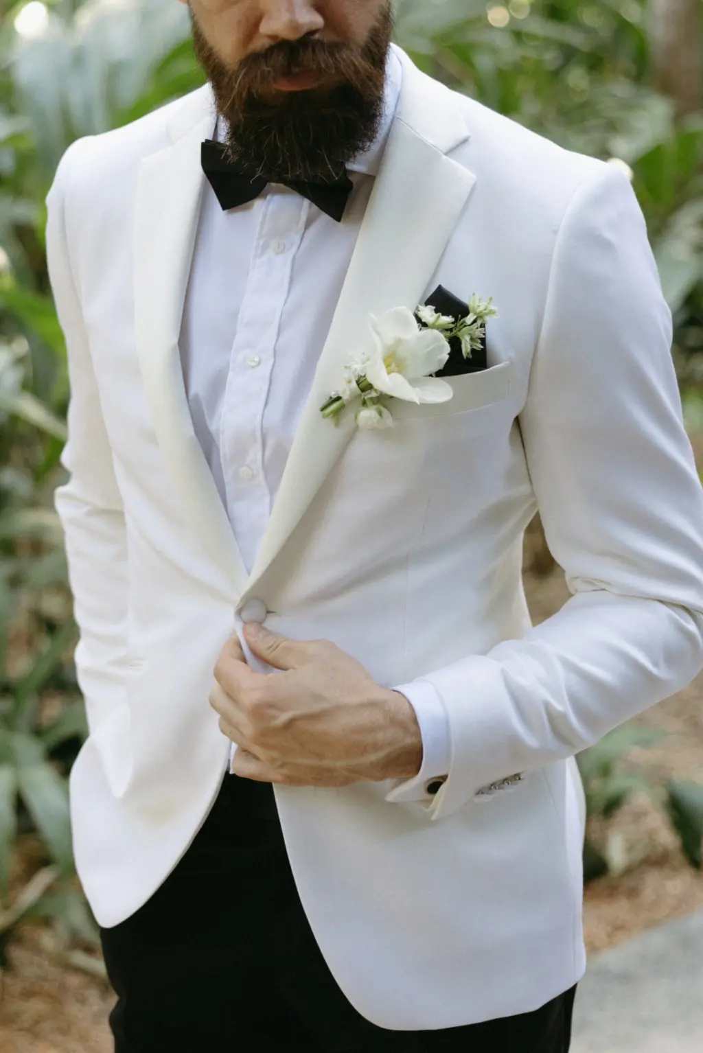 Black and White Wedding Groom Tuxedo and Bowtie Ideas | White Cosmos Boutonniere Inspiration
