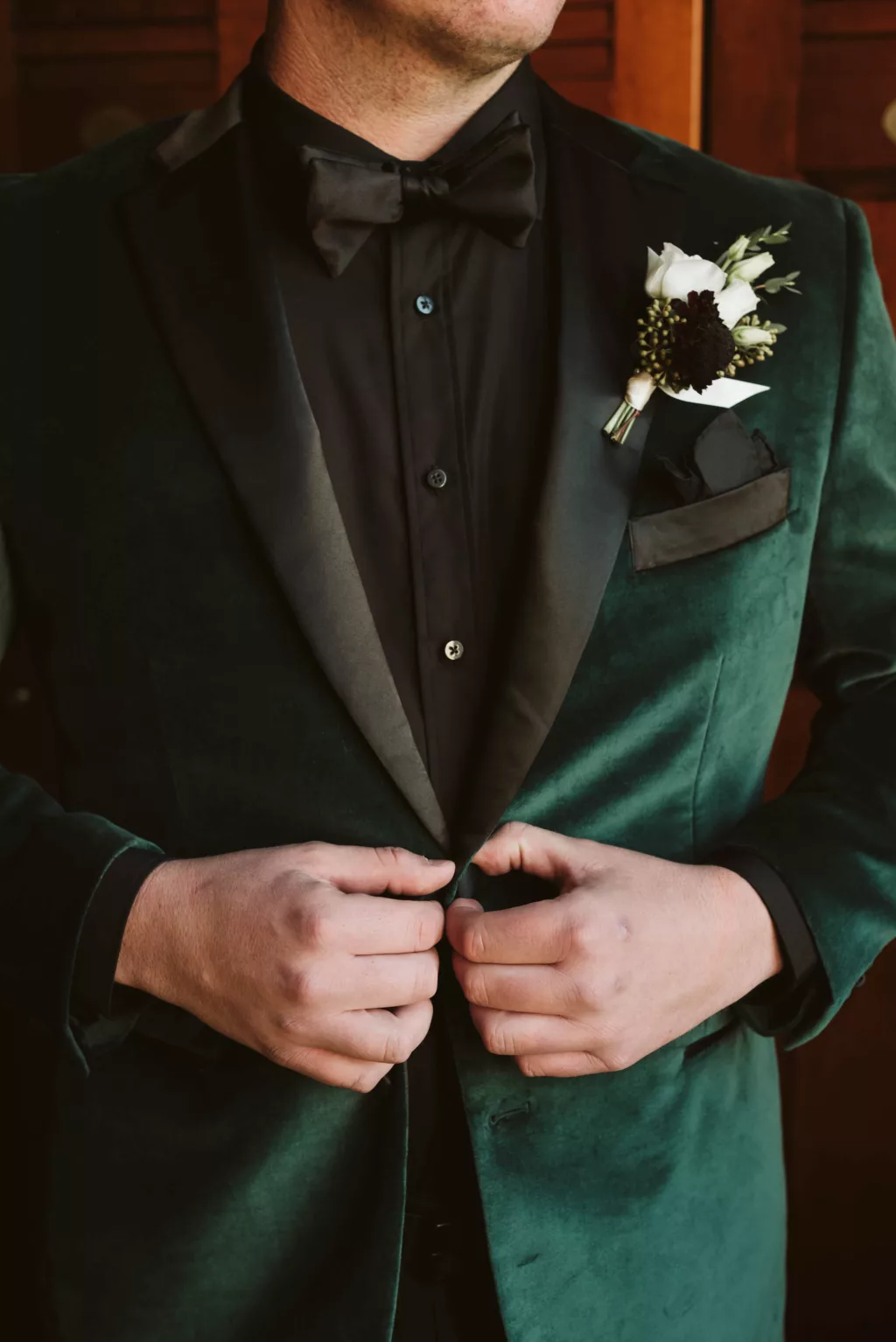 Groom's Green Velvet and Black Tuxedo Jacket Wedding Attire Ideas | White Baby Spray Roses and Purple Chrysanthemum Boutonniere Inspiration