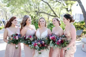 Mismatched Pink Sequin Bridesmaids Dress Ideas | White and Nude Deep V Neckline Lace and Tulle Mermaid Wedding Dress with Cathedral Length Train Inspiration | Romantic Hair and Makeup Look | Pink Roses, Spray Roses, Burgundy Chrysanthemums, Blue Thistles, and Greenery Bouquet | Tampa Bay Hair and Makeup Artist Michele Renee The Studio