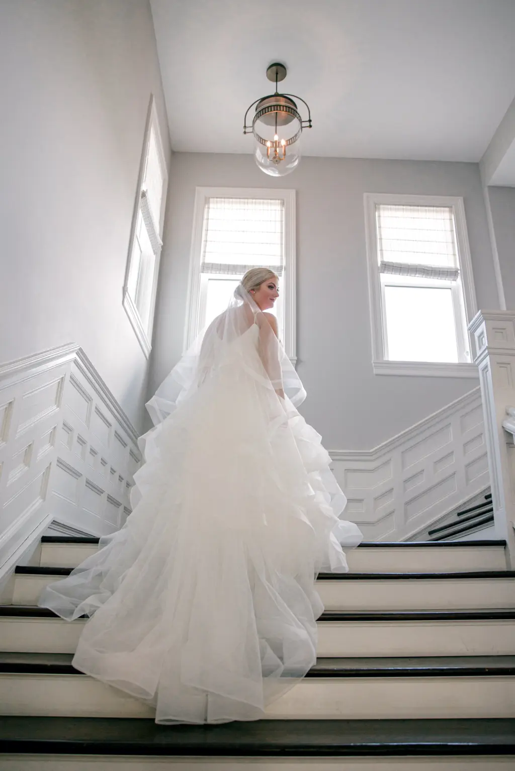 Bride Walking up the Stairs in Elegant White Tiered Tulle A-Line Sophia Tolli Wedding Dress Ideas