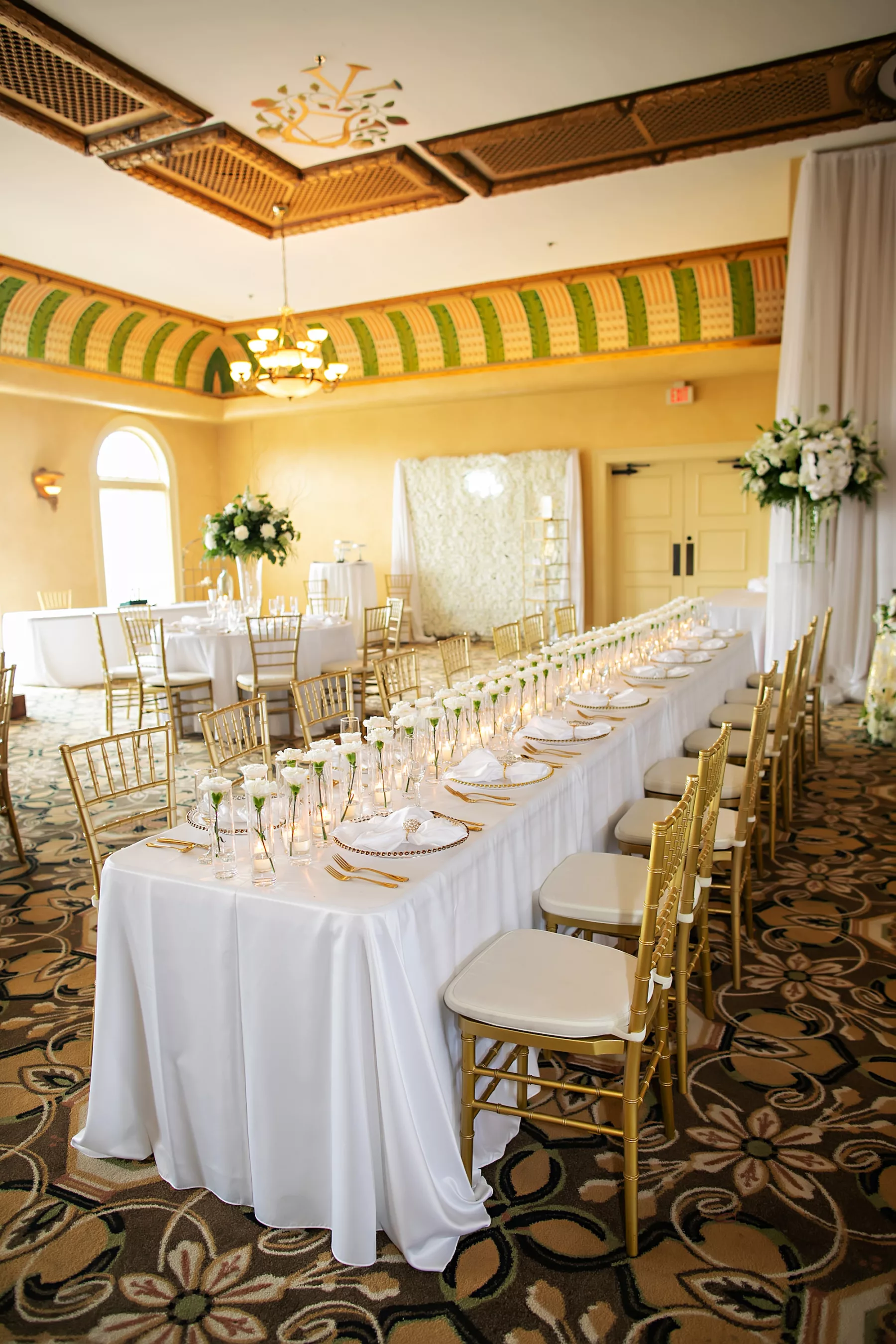 Classic White and Gold Wedding Reception Feasting Tables with Single White Carnation in Glass Vase Centerpiece Inspiration