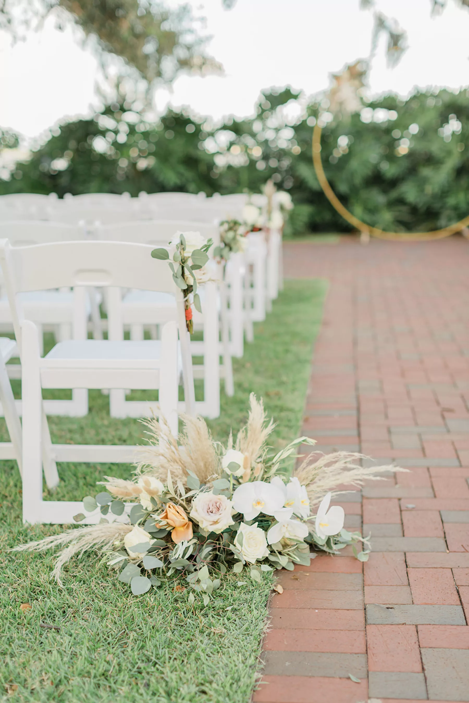 Boho Wedding Ceremony Aisle Decor Ideas | White Roses and Orchids, Pampas Grass, and Greenery | Folding Garden Chairs Seating Inspiration