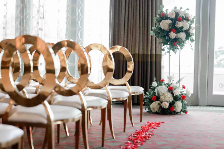 Indoor Grand Ballroom Wedding Ceremony Inspiration | Gold Oval Top Chair Ideas | Pink Rose Petal Aisle Decor