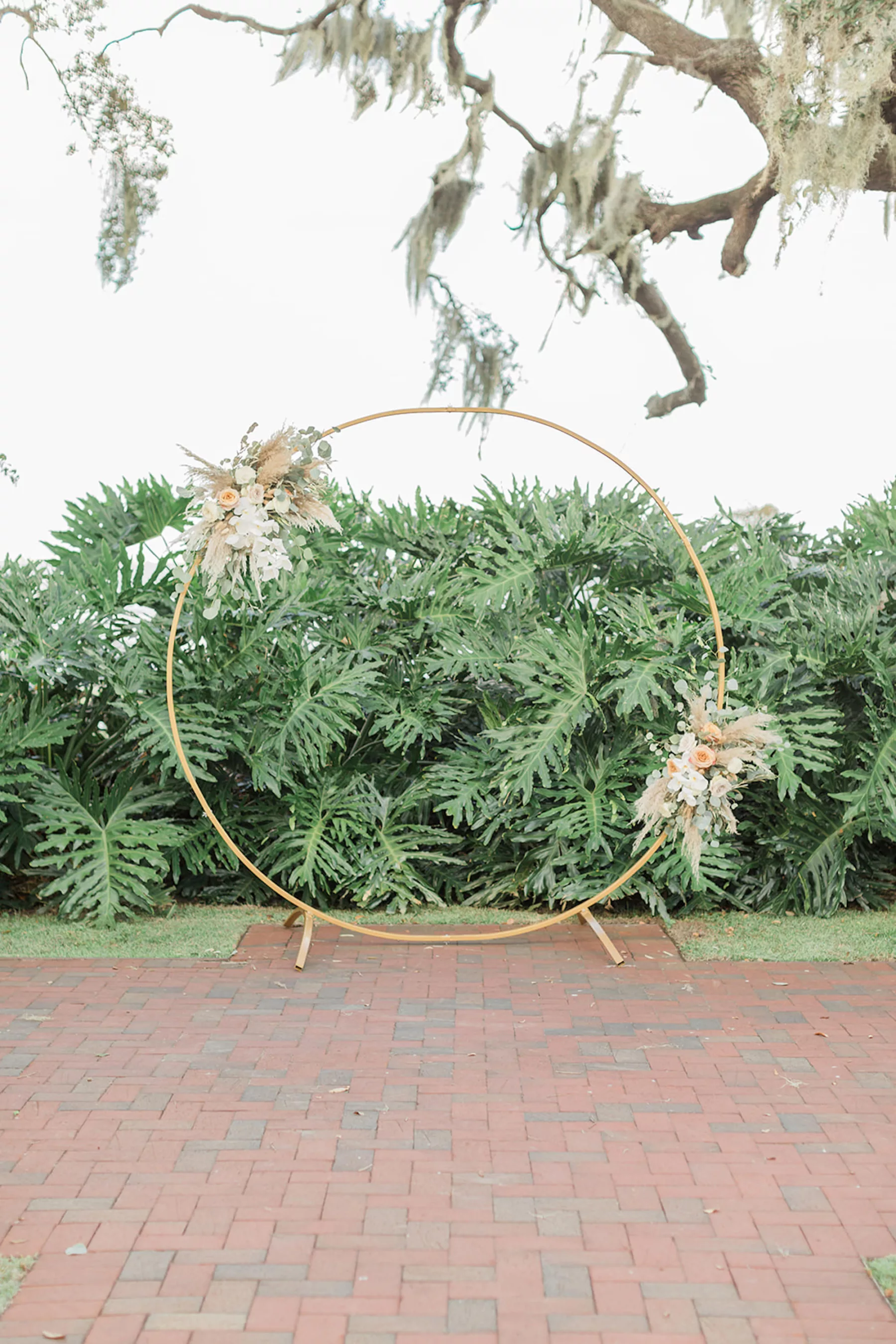 Boho Wedding Ceremony Altar Decor Inspiration | Gold Round Arch with White and Orange Roses, Pampas Grass, Greenery, and Orchids