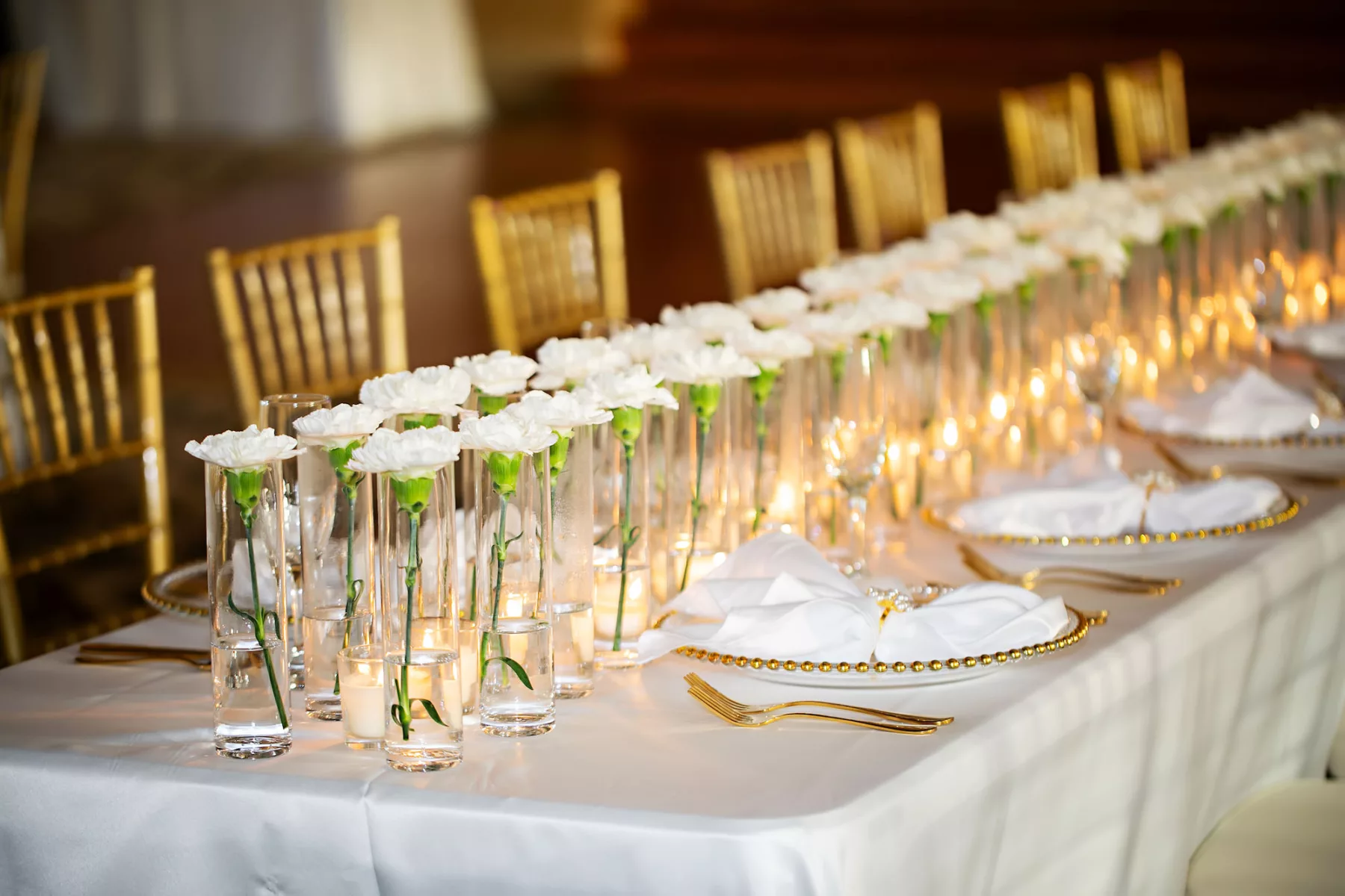 Classic Wedding Reception Gold Rimmed Beaded Chargers with Gold Flatware Tablescape Place Setting Ideas | Single White Carnation in Glass Vase and Candles Centerpiece Inspiration | Ybor Event Rentals Outside The Box Rentals | Tampa Bay Photographer Limelight Photography