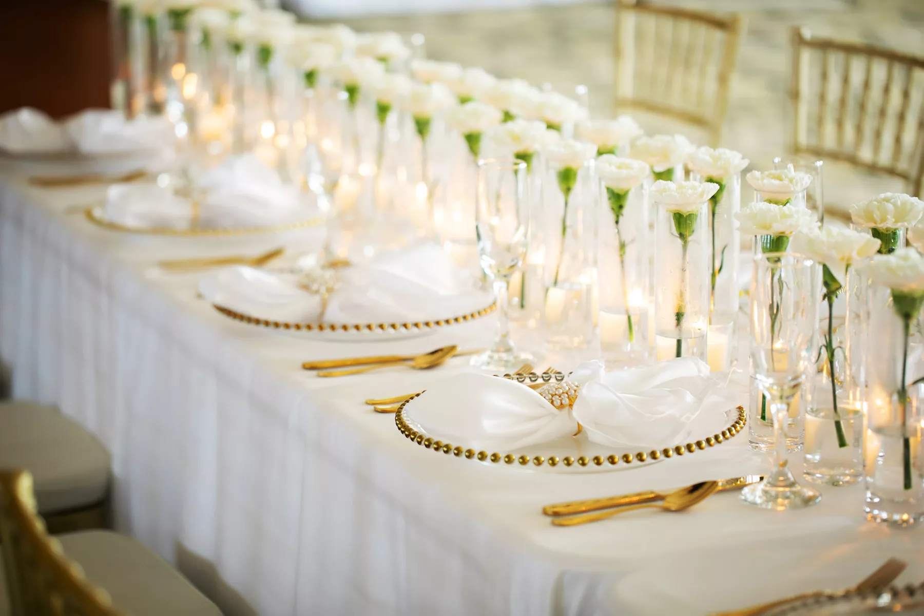 Classic Wedding Reception Gold Rimmed Beaded Chargers with Gold Flatware Tablescape Place Setting Ideas | Single White Carnation in Glass Vase and Candles Centerpiece Inspiration | Ybor Event Rentals Outside The Box Rentals