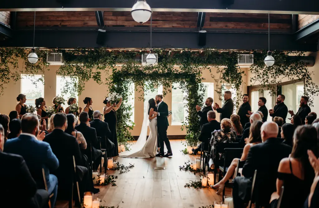 Classic Cascading Lush Greenery Arch Indoor Wedding Ceremony Inspiration | Candlelight Aisle Decor Ideas | Tampa Bay Photographer Videographer Sabrina Autumn Photography | Tampa Bay Event Venue Oxford Exchange | Planner Wilder Mind Events
