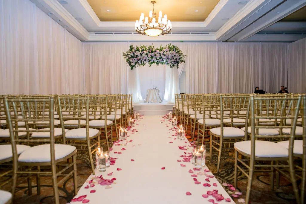 Elegant White and Gold Ballroom Jewish Wedding Ceremony with Chuppah Inspiration | Gold Chiavari Chairs | Floating Candles and Rose Petal Aisle Decor Ideas | Kate Ryan Event Rentals | Clearwater Beach Event Venue Sandpearl Resort Hotel