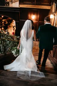 Romantic Bride and Groom on the Stairs Wedding Portrait | Modern Black and White Wedding Decor Inspiration | Groom's Green Velvet Tuxedo Jacket Ideas | Satin Classic Mermaid Wedding Dress Inspiration | Tampa Bay Photographer Videographer Sabrina Autumn Photography | Downtown Tampa Event Venue Oxford Exchange