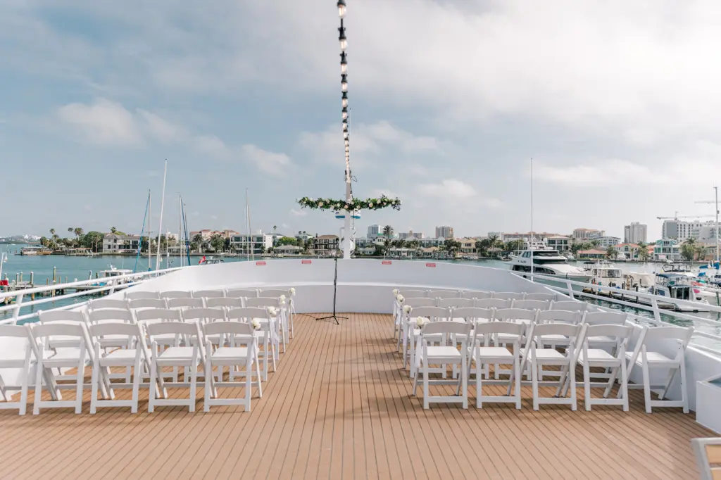 Black Tie Wedding Ceremony Decor | Folding Garden Chairs, White Roses and Greenery Garland Inspiration | Clearwater Event Venue Yacht StarShip