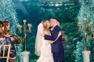Bride and Groom First Kiss Coral Reef Gallery Wedding Ceremony Ideas | Gold Crystal Bead Candelabra Altar Decor Inspiration | Tampa Bay Planner Breezin Weddings | Photographer Lifelong Photography Studios