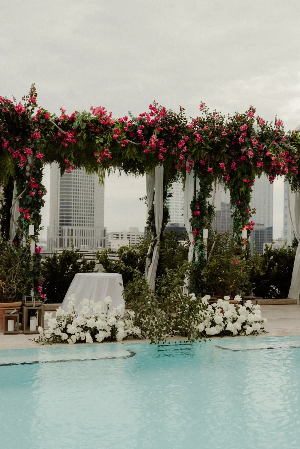 Bougainvillea Rooftop Pool Wedding Ceremony Arch Decor Ideas with White Roses and Greenery | Tampa Bay Planner Breezin Weddings | Downtown Tampa Event Venue The Edition Hotel
