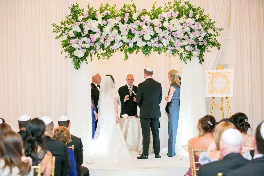 Jewish Wedding Ceremony Ideas | Whimsical Chuppah with Pink and Purple Roses, White Hydrangeas, and Greenery
