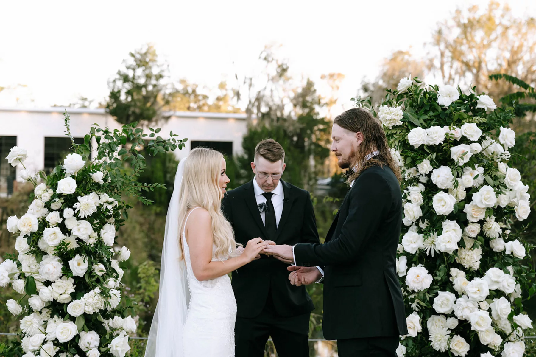 Bride and Groom Wedding Vow Exchange | Asymmetrical Floral Arbor with White Roses and Greenery Ideas | Tampa Bay Florist Bloom Shakalaka | Event Planner Kelci Leigh Events