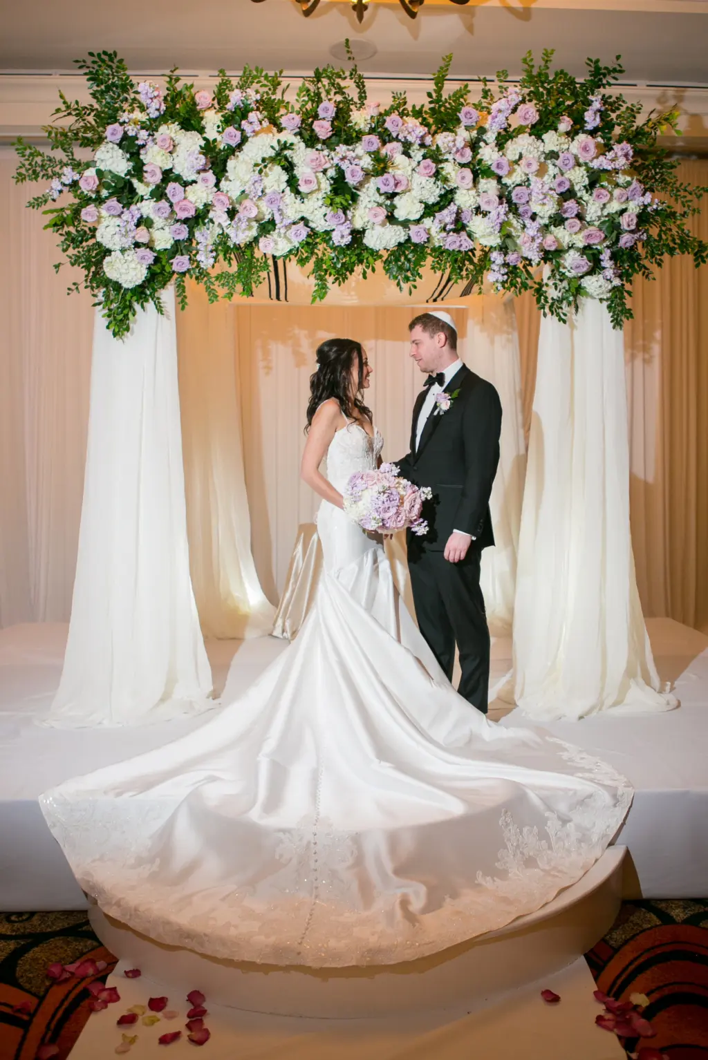 Bride and Groom Just Married Portrait | Elegant Jewish Black Tie Wedding Ceremony Chuppah with Drapery, Pink and Purple Roses, White Hydrangeas, and Greenery Inspiration | Tampa Bay Boutique Truly Forever Bridal | Photographer Carrie Wildes Photography