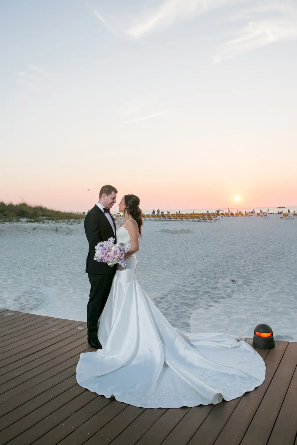 Bride and Groom Sunset Clearwater Beach Wedding Portrait | White Removable Spaghetti Strap Lace and Satin Mermaid Wedding Dress Inspiration | Tampa Bay Boutique Truly Forever Bridal | Tampa Bay Event Venue Sandpearl Resort Hotel | Photographer Carrie Wildes Photography