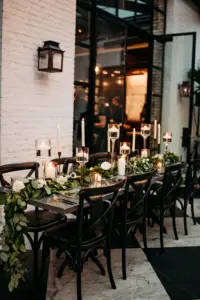 Modern Romantic Black and White Conservatory Wedding Reception Inspiration | Floating Candles, White Roses, and Greenery Garland Centerpiece Decor Ideas | Tampa Event Venue Oxford Exchange | Planner Wilder Mind Events