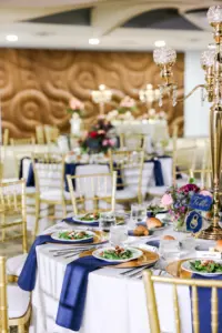 Romantic Pink and Blue Wedding Reception Sweetheart Table Decor Ideas | Gold Chiavari Chairs and Chargers | Hand Lettered Table Numbers | Tall Gold Crystal Beaded Candelabra Centerpiece Inspiration