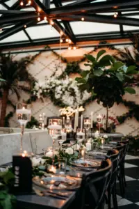 Modern Romantic Black and White Conservatory Wedding Reception Inspiration | Floating Candles, White Roses, and Greenery Garland Centerpiece Decor Ideas | Tampa Bay Planner Wilder Mind Events | Downtown Event Venue Oxford Exchange