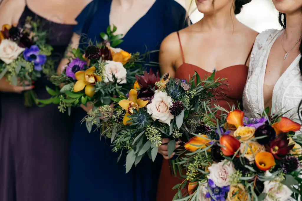 Fall Bridal Party Bouquet Inspiration | Blush Roses, Blue Thistle Flowers, Yellow Orchids, Orange Calla Lily, Red Cosmos and Greenery