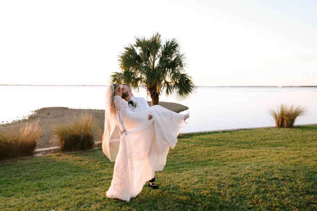 Bride and Groom Sunset Waterfront Wedding Portrait | Sarasota Videographer Shannon Kelly Films | Venue Powel Crosley Estate