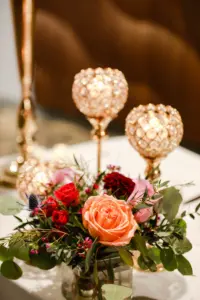Elegant Orange and Pink Roses, Burgundy Chrysanthemums, Blue Thistle, and Greenery with Gold Beaded Crystal Candle Holder Wedding Reception Decor Centerpiece Ideas