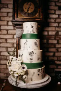 Round White with Black Painted Abstract Modern Buttercream Four-Tiered Wedding Cake with Green Fondant Borders Inspiration | White Roses, Anemone, and Greenery Garnish Accents