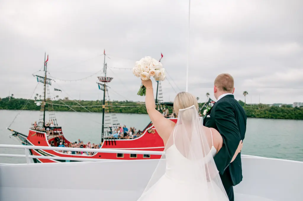 Bride and Groom Just Married Waterfront Wedding Portrait with Pirate Ship | Clearwater Venue Yacht StarShip