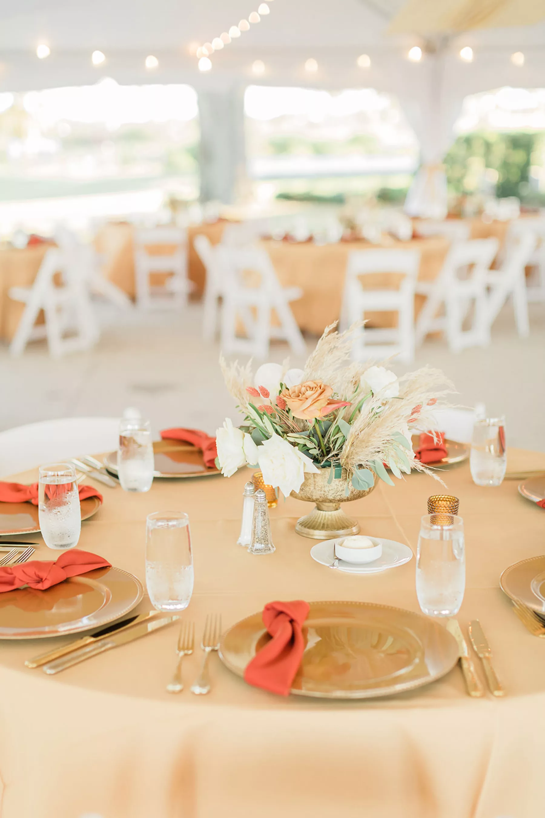 Boho Outdoor Fall Wedding Reception Tablescape Inspiration | Neutral Peach Table Cloth and Burnt Orange Napkins | White and Orange Roses, Pampas Grass, and Greenery Centerpiece Ideas