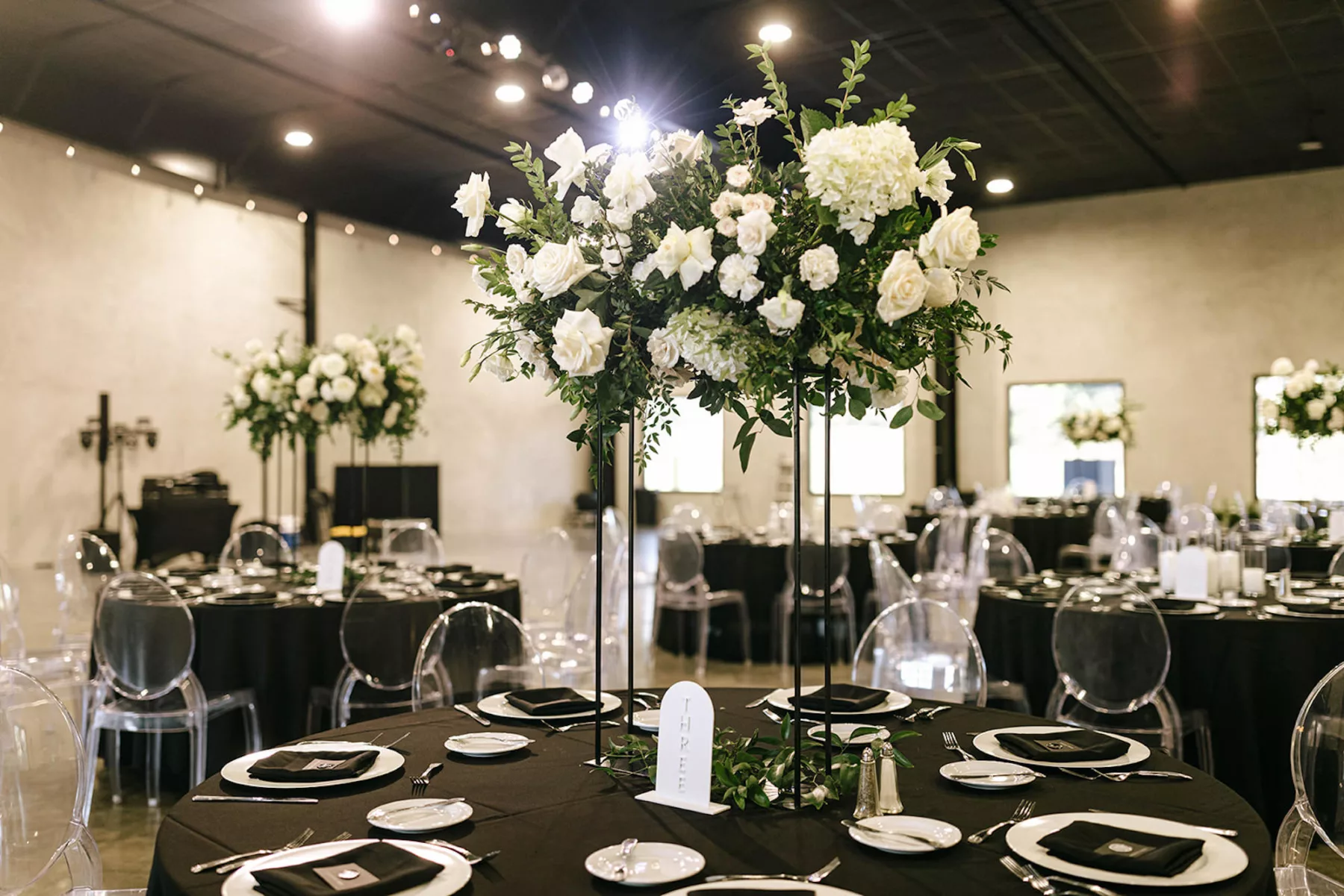 Tall Black Flower Stand with White Roses, Hydrangeas, and Greenery Centerpiece Decor Ideas | Moody Modern Wedding Reception Tablescape Inspiration | Tampa Bay Florist Bloom Shakalaka | Caterer Amici's Catering