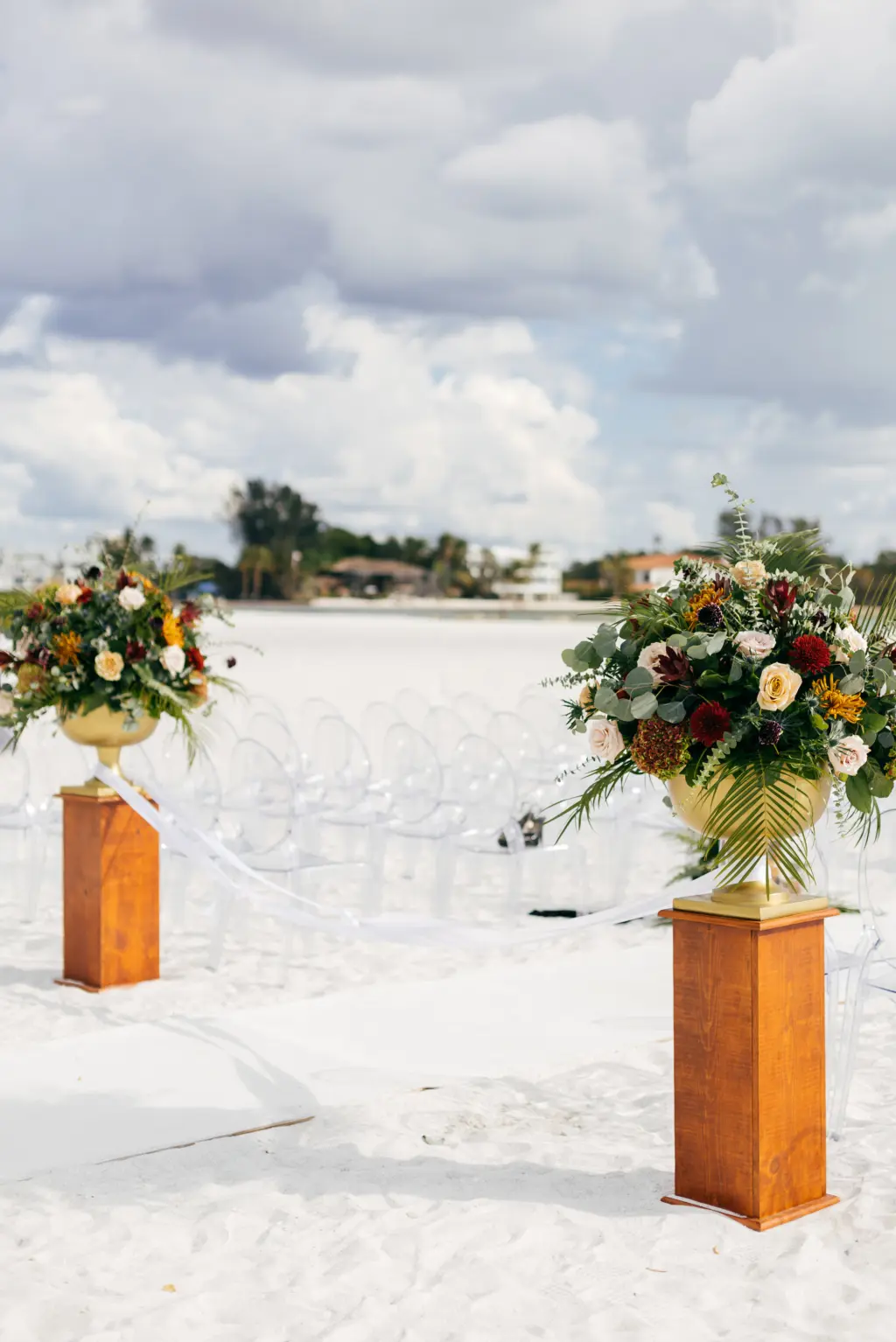 Moody Fall Black Tie Beach Wedding Ceremony Decor Inspiration | Jewel Tone Floral Arrangements in Gold Vases on Columns at Ceremony Aisle
