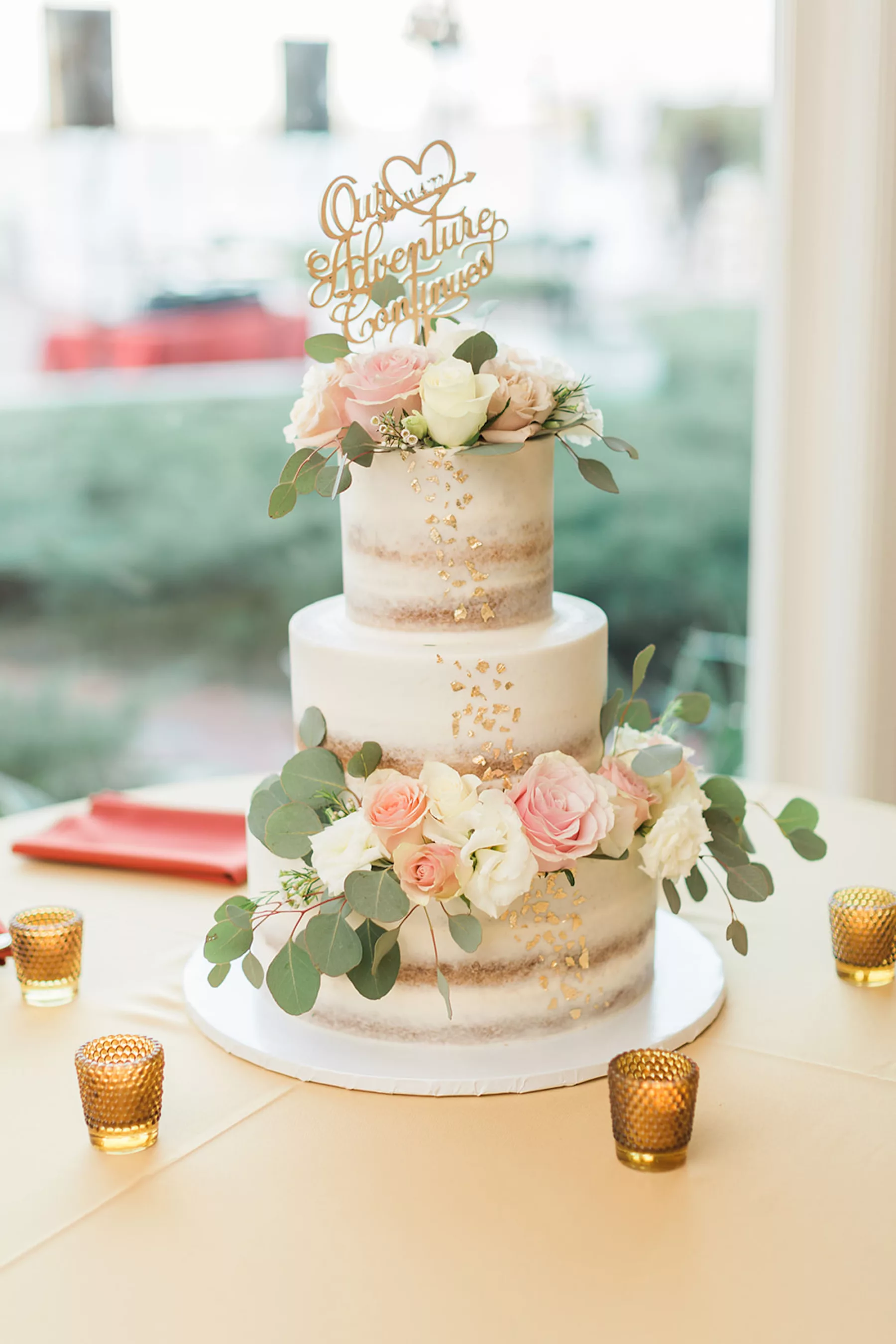 Round Three-Tiered Semi-Naked Wedding Cake with Gold Foil, Pink and White Roses, Gardenias, and Eucalyptus Greenery Accents Inspiration