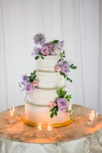 White Round Four-tiered Buttercream Wedding Cake with Purple and Pink Rose Accents