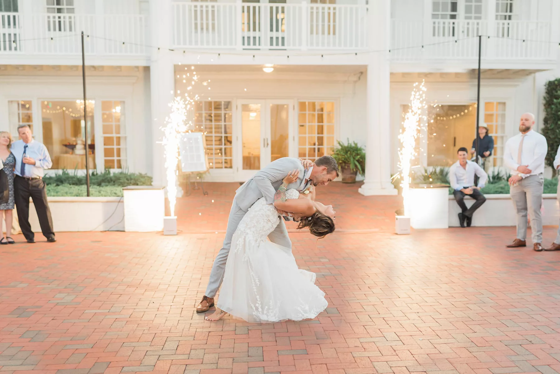 Bride and Groom First Dance Outdoor Terrace Wedding Reception | Market String Lights and Cold Spark Machines Decor Entertainment Inspiration