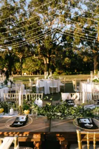 Romantic White and Gold Outdoor Italian Wedding Reception Decor with String Light Canopy Ideas | Woof Farm Feasting Tables with Round White Linens and Gold Chiavari Chairs