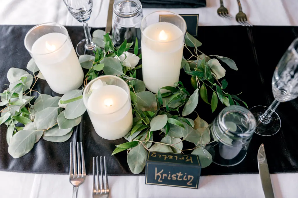 Black and White Wedding Reception Decor Inspiration | Pillar Candles and Eucalyptus Greenery Centerpiece Ideas | Handwritten Place cards