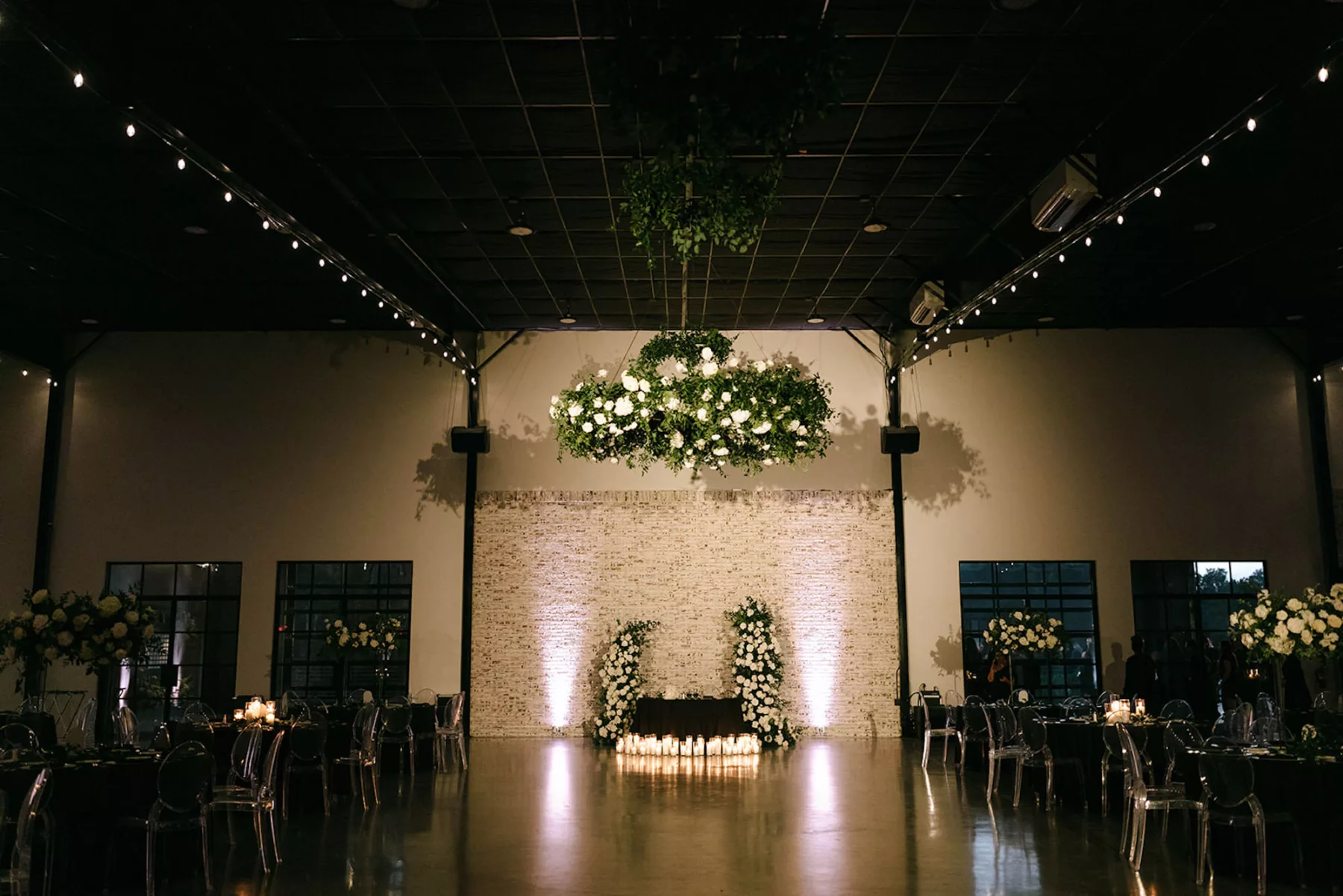 Moody Modern Black and White Wedding Reception Sweetheart Table Candlelight Decor Inspiration | White Rose, Hydrangeas, and Greenery Floral Chandelier Ideas | Tampa Bay Florist Bloom Shakalaka | Event Planner Kelci Leigh Events | Venue White Rock Canyon