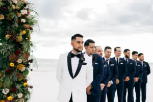 Groom Watching Bride Walk Down Wedding Aisle | Fall Black Tie Wedding Ceremony | Black and White Tuxedo Ideas | Black and Navy Groomsmen Suit Inspiration