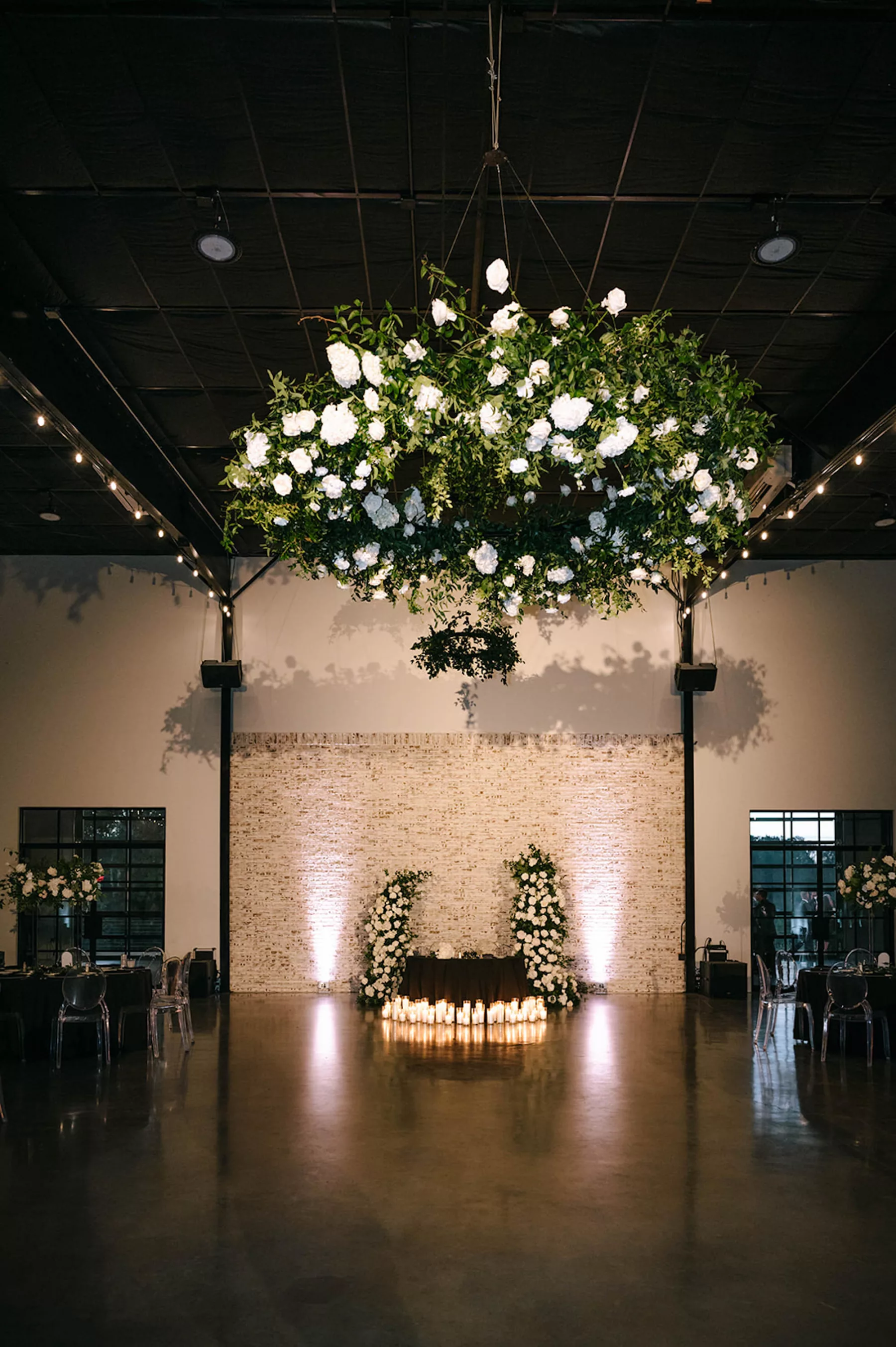 Moody Modern Black and White Wedding Reception Sweetheart Table Candlelight Decor Inspiration | White Rose, Hydrangeas, and Greenery Floral Chandelier Ideas | Tampa Bay Florist Bloom Shakalaka | Planner Kelci Leigh Events