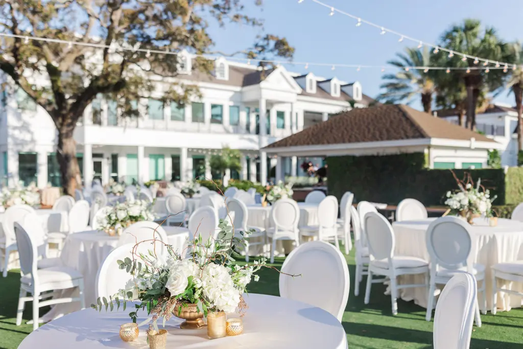 White Southern Outdoor Black-Tie Wedding Reception Decor Inspiration | White Roses, Hydrangeas, and Greenery, Gold Votives Centerpiece Ideas | White King Louis Dining Chairs | Tampa Bay Florist Botanica Design Studio | South Tampa Venue Palma Ceia Golf and Country Club