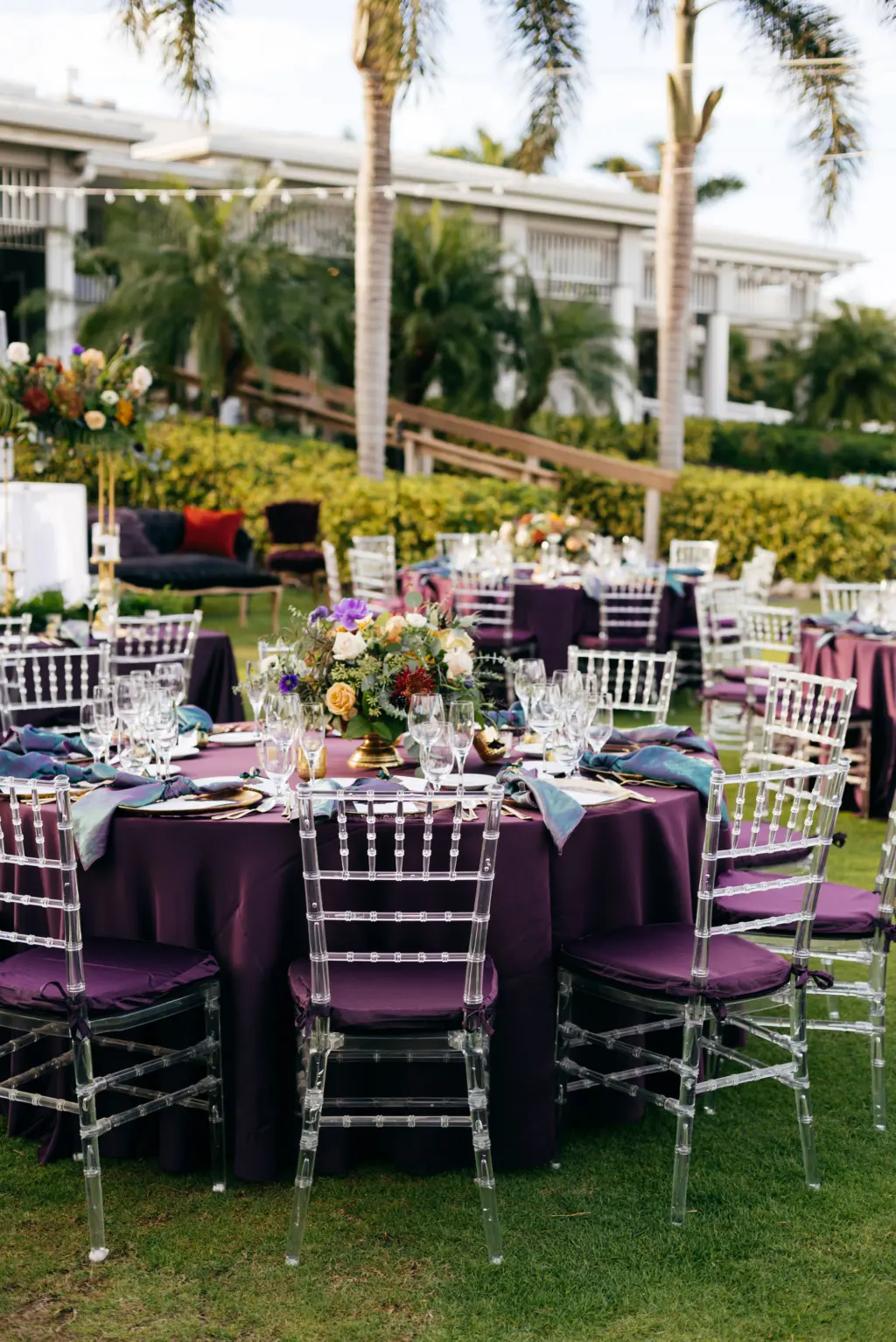 Jewel-Toned Moody Fall Wedding Reception Table Decor Ideas | Ghost Chiavari Chairs | Sarasota Event Venue The Resort at Longboat Key Club | Dark Purple Eggplant Table Linen with Gold Glass Charger Plate and Iridescent Napkin